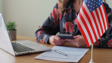 American,Woman,Consular,Officer,Giving,Passport,To,Male,Immigrant,,Work