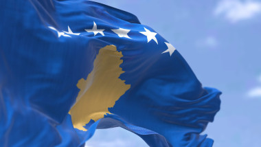 Detail of the national flag of Kosovo waving in the wind on a clear day