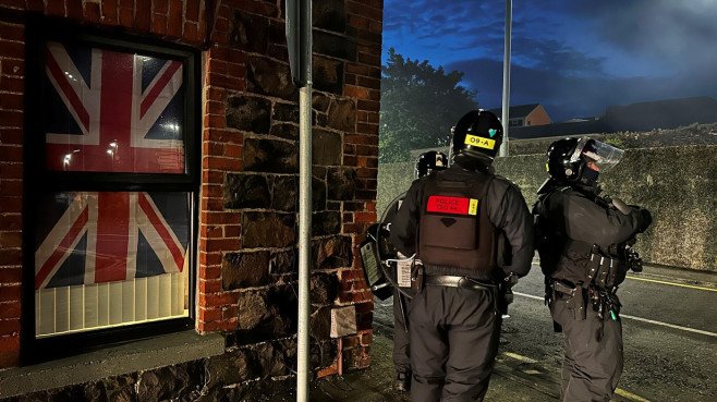Police officers on Clonavon Road in Ballymena following a second night of violence in Ballymena, during a protest over an alleged sexual assault in the Co Antrim town. Multiple cars and properties were set on fire in Ballymena while rioters hurled petrol