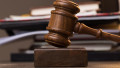 Folder, judge's hammer on table