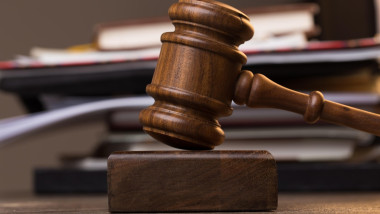 Folder, judge's hammer on table