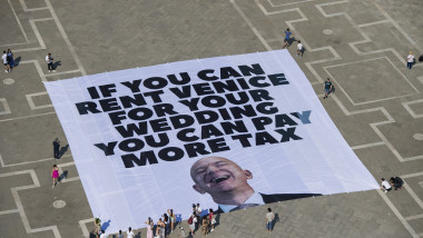 Protestors reveal a giant banner in Venice telling Jeff Bezos to pay more tax ahead of his wedding to Lauren Sanchez.