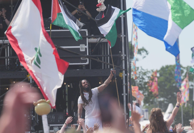 Previously unissued photo dated 28/6/2025 of Bob Vylan stands amongst the crowd holding the flag of Palestine, during his performance on the West Holts Stage, during the Glastonbury Festival at Worthy Farm in Somerset. Glastonbury Festival has said it is