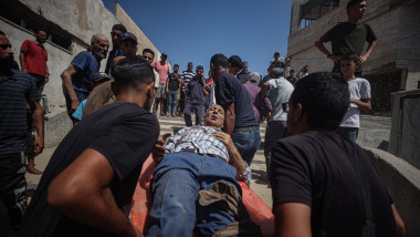 Palestinians carry an injured person out of Al-Baqa Cafe, Gaza city, Gaza Strip, Palestinian Territory - 30 Jun 2025