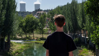A youngster looks at the river and Trillo nuclear power plant from a bridge in the Guadalajara province in Spain.