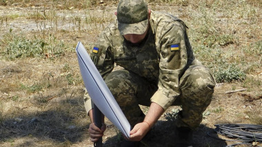 Russian pro-war fanatics praise 'Colonel Elon Muskov' amid admissions Elon Musk's Starlink satellite equipment is in use by the Russian armed forces in occupied Ukraine. Pictured: Ukrainian soldier setting up Starlink satellite equipment