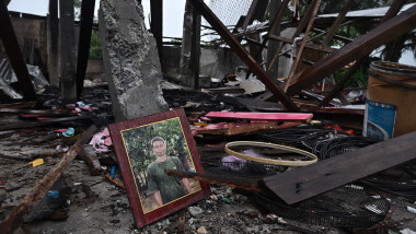 A portrait lies in an evacuated house that was destroyed by fire after being hit by Cambodian artillery that morning, in the Thai border province of Surin