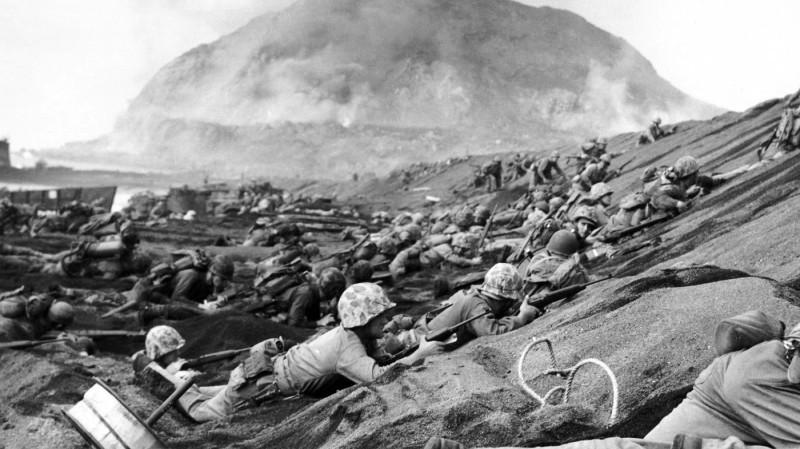 Japan / USA: US Marines assault a beach at Iwo Jima, Mount Suribachi in the background, February 1945