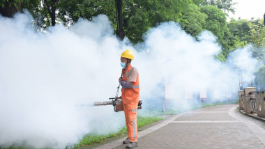DONGGUAN, CHINA - AUGUST 03: A sanitation worker sprays insecticide to prevent the spread of Chikungunya on August 3, 20