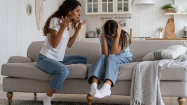 Angry woman mother shouting at teenage daughter trying to discipline child, yelling at kid
