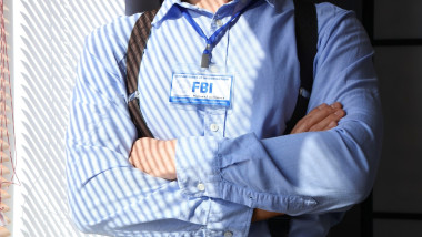 FBI agent near window in office, closeup