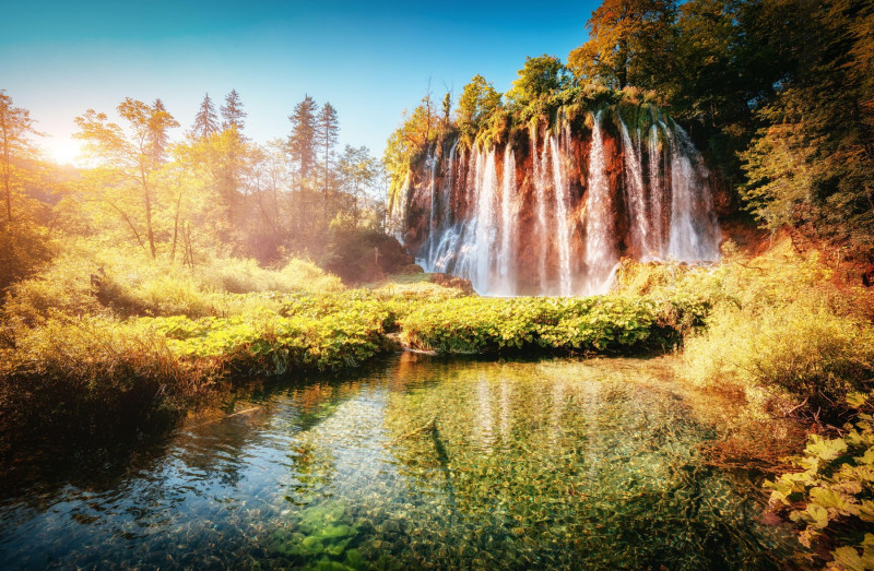 Majestic view on turquoise water and sunny beams. Unusual and gorgeous scene. Location famous resort Plitvice Lakes National Park, Croatia, Europe. Be