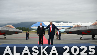 US President Donald Trump (R) and Russian President Vladimir Putin pose on a podium on the tarmac after they arrived at Joint Base Elmendorf-Richardson in Anchorage, Alaska