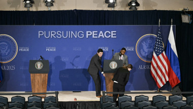 Staff members set up the stage ahead of the US-Russia summit on Ukraine with US President Donald Trump and Russian President Vladimir Putin at Joint Base Elmendorf-Richardson in Anchorage