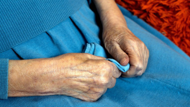 Hands of a very old woman with wrinkled skin. Longevity. Loneliness of old people