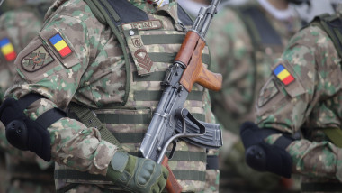 Bucharest, Romania - January 24, 2024: Details with a Romanian army soldier holding an AK 47 assault rifle during a military ceremony at the Monument