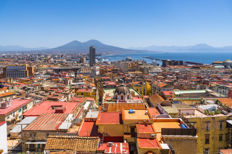 Naples cityscape with Mount Vesuvius in background, showcasing Italian urban landscape