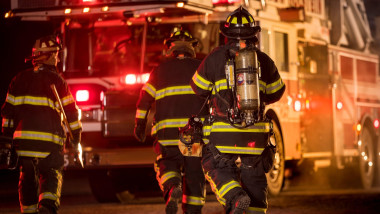 Three firefighters with different fire equipment, New Holstein, Wisconsin, USA