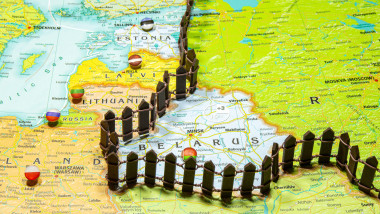 Concept of common border Russia and Belarus. Fence separating from European countries NATO Latvia Lithuania and Estonia. Close up picture on a colorfu