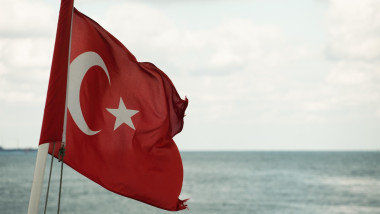 Turkish flag at boat with sea water in background; Bosporus strait, Istanbul, Turkey