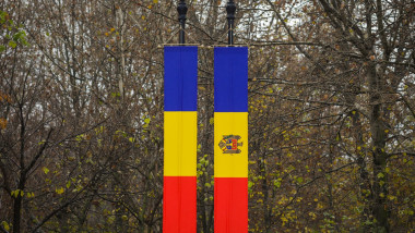 Details with the Romanian and Republic of Moldova flags with autumn trees in the background.