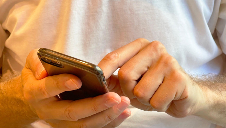 Man’s handd using smartphone.