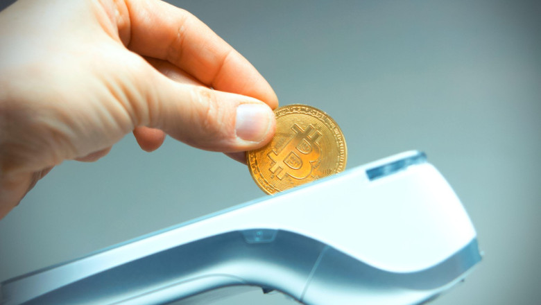 Creative photo, inserting a Bitcoin on a card machine. Electronic payment. Banking and technology