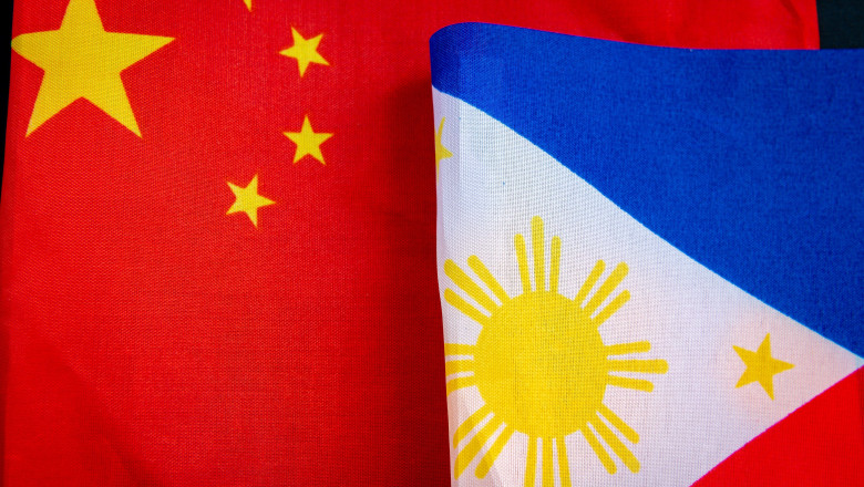 A close up of the national flag of China next to the Philippines national flag. A China, Philippines relations concept.