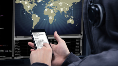 Hacker Using Mobile Phone For Stealing Data From Computer