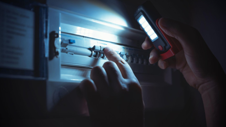 Investigate a home fuse box during a power outage. Blackout concept