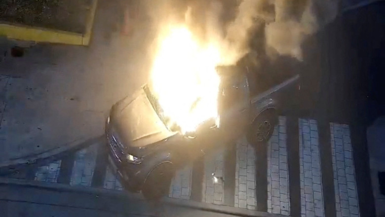 Flames rise from a vehicle that exploded outside a shopping mall, in Guayaquil