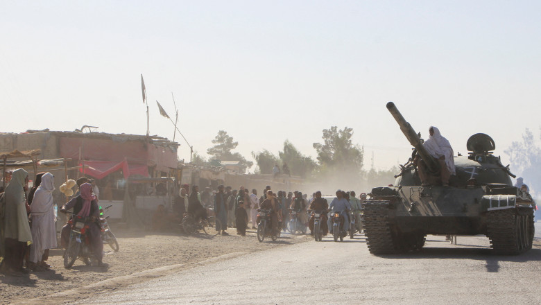 An Afghan Taliban fighter sits on a tank near the Afghanistan-Pakistan border in Spin Boldak, Kandahar Province, following exchanges of fire between Pakistani and Afghan forces