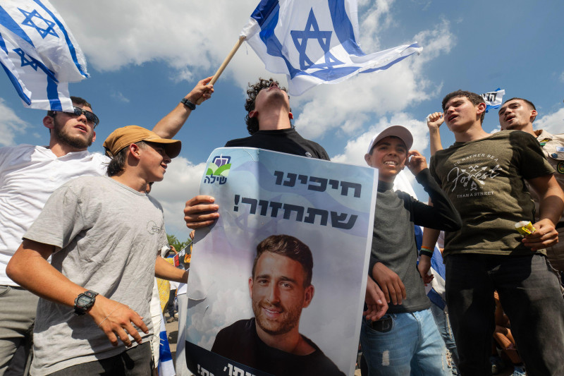 Friends and supporters of the hostage Avinatan Mor dance while holding his picture. Avinatan, who was released after two years in Hamas captivity, was freed as part of President Trump’s deal to end the war. The people of Israel celebrated the release of t