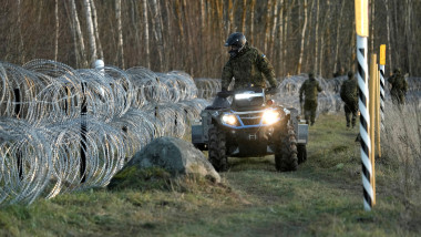 Estonian army reservists build a fence on a border with Russia near Meremae