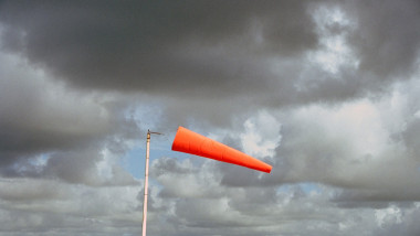 one red wind sock and dramatic sky