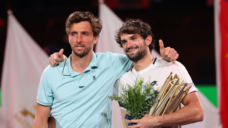 Monaco's Valentin Vacherot celebrates with the trophy and France's Arthur Rinderknech after winning the final