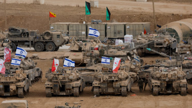 Military vehicles are gathered near the Israel-Gaza border, amid a ceasefire between Israel and Hamas in Gaza