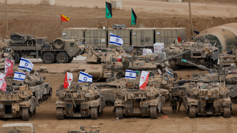 Military vehicles are gathered near the Israel-Gaza border, amid a ceasefire between Israel and Hamas in Gaza