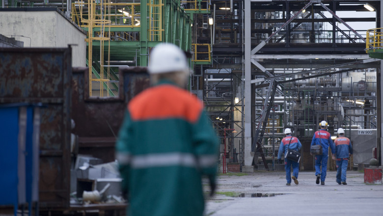 An employee walks through the Petrolchemie and Kraftstoffe oil refinary in Schwedt/Oder