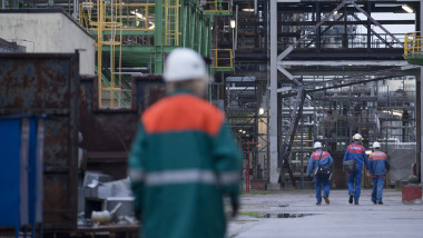 An employee walks through the Petrolchemie and Kraftstoffe oil refinary in Schwedt/Oder
