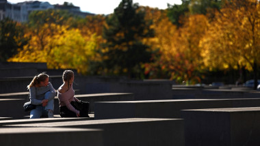 fete care stau jos si peisaj de toamnă