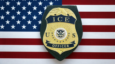 KYIV, UKRAINE - SEPTEMBER 17, 2025 US ICE Officer badge on United States of America flag close up