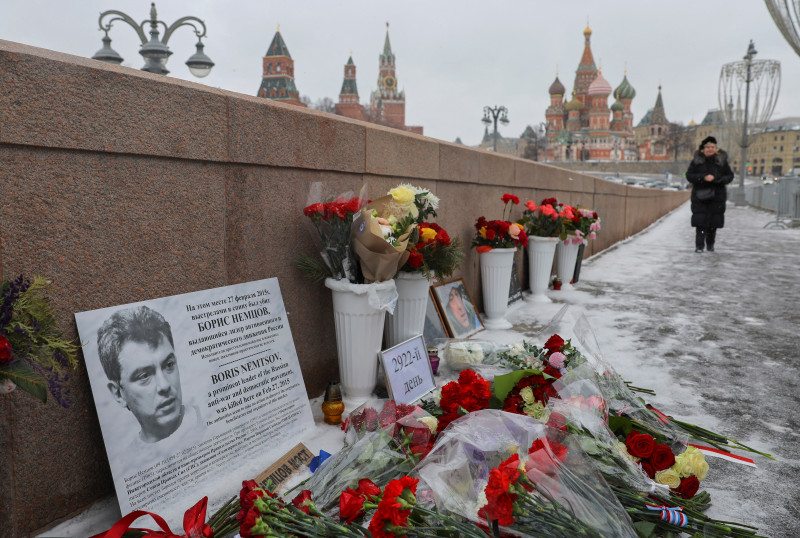 People lay flowers in memory of Russian opposition politician Boris Nemtsov in Moscow