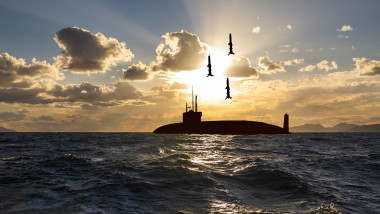 Submarine missile launch. Nuclear submarine at sea at sunset.