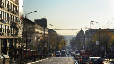 Belgrad street with many vehicles on the road at sunset.