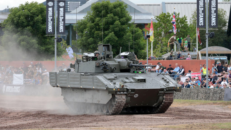 A British Army Ajax armoured reconnaissance vehicle driving around the arena at Bovington Tank Museum during Tankfest 2024