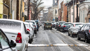Snowing on cars in the morning, snow on street in Bucharest, Romania, 2021