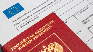 Flat lay of Russian passport and Schengen visa paper, international travel concept, migration crisis, tourism under sanctions, document for emigration