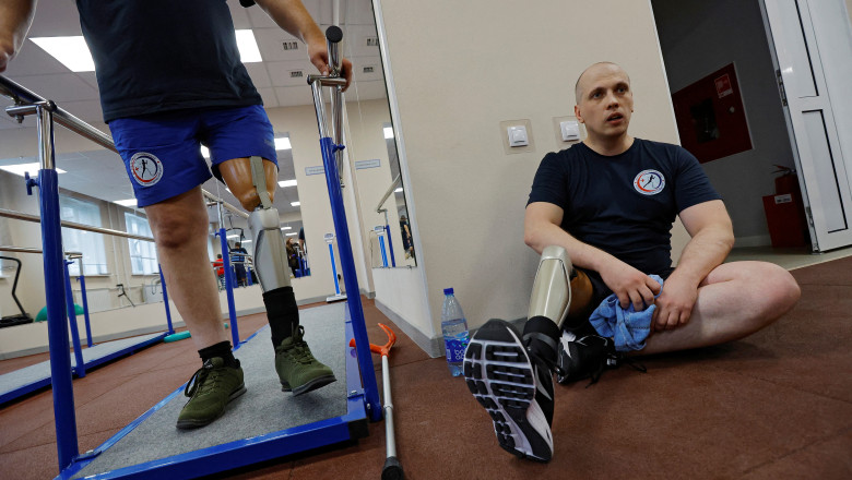 A Russian service member learns to walk with a prosthetic leg in Donetsk