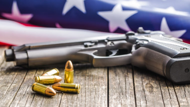 Pistol bullets, handgun and USA flag.